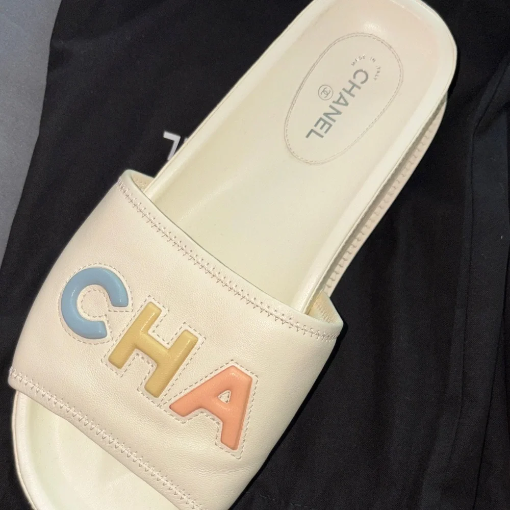 CHANEL White Leather Slide Sandals with Pastel Lettering